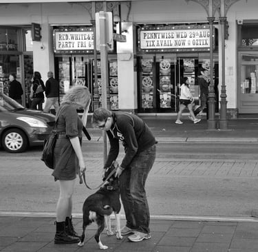 The lens of photographer Peter Pickering captures a couple with their dog in a Fremantle street