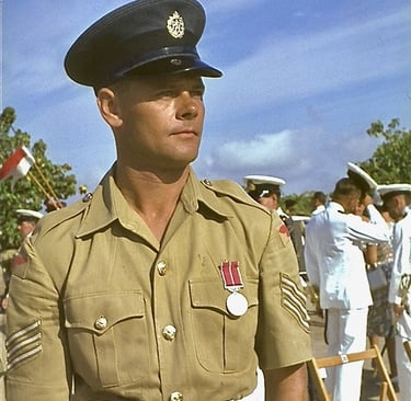 Sgt Roland Pickering B.E.M. in uniform standing in front of a group of people
