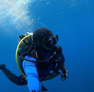 a person in a scuba suit is holding a scuba suit