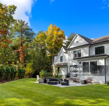 a large backyard with a fire pit and a patio