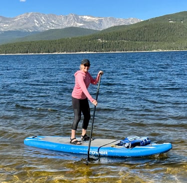 Behavioral psychologist and menopause coach Becca Borden paddling rough waters in the mountains