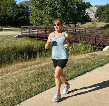 behavioral psychologist and menopause coach Becca Borden using strong muscles to run outside