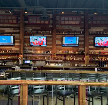 TV wall-mounted by At Hand Heroes in Peoria restaurant with concealed wiring and clean finish.