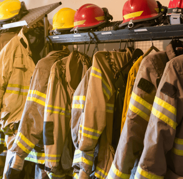 a bunch of fire fighters are lined up on a rack