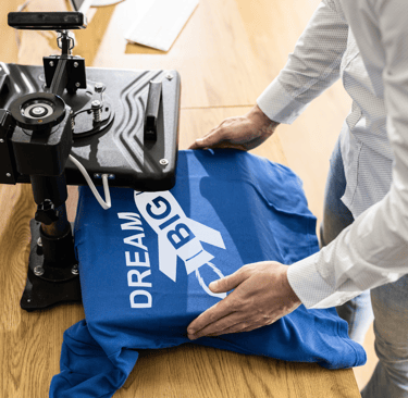 a person is holding a blue shirt and a blue shirt