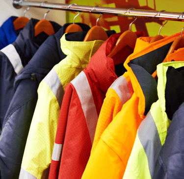 a bunch of clothes hanging on a rack