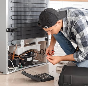 a person repairing a fridge