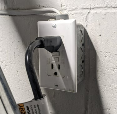 Black plug is connected to a GFCI protected outlet