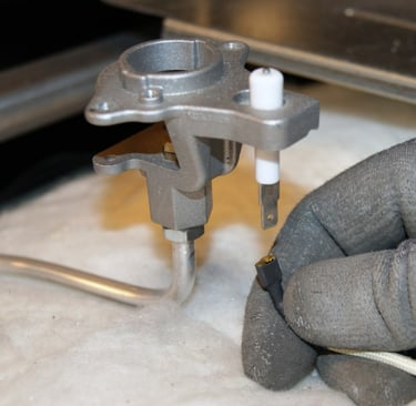 A technician holding an range igniter spark plug