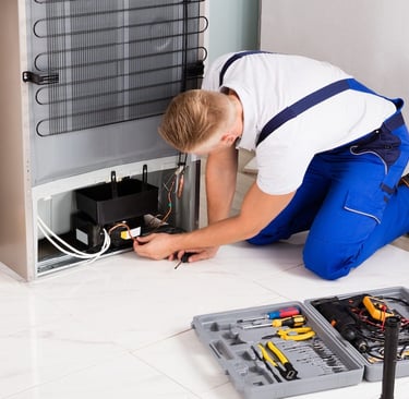 a technician repairing a compressor of a refrigerator