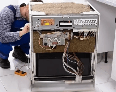 a technician repairing a dishwasher front panel is removed