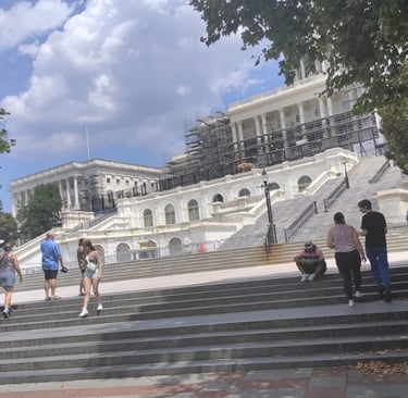 a group of people walking up stairs in front of a building