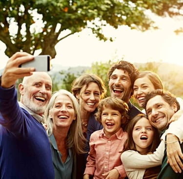 a group of people taking a selfie with a cell phone