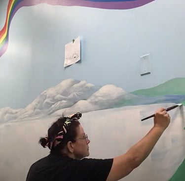 Marcine painting a bespoke mural at a Union County, NJ preschool