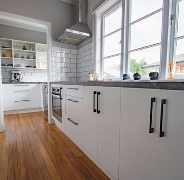 eco friendly flooring options for a kitchen with a wooden floor and white cabinets