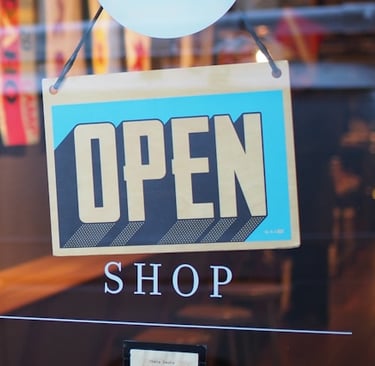 a sign that says open shop, business formation lawyer