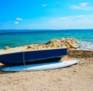 a surfboarder sitting on the beach, best tourist cities in Croatia