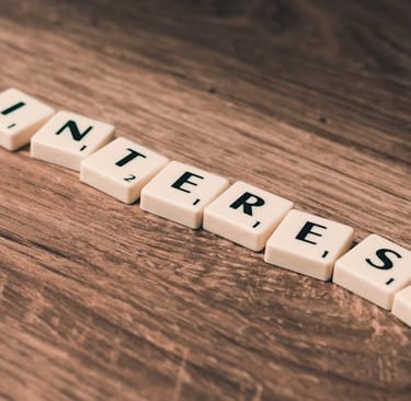 Pinterest word spelled out with letter tiles on a rustic wooden table for social media marketing.