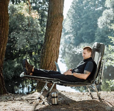a man sitting on a chair in a park, how to become a digital nomad