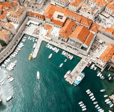a cityscape of boats in the water, island hopping in Croatia