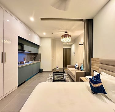 Luxury bedroom with a bed, couch, and kitchen