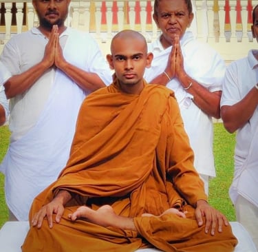 a man in a monk robe sitting in a meditation position