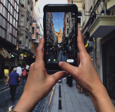 a person holding a cell phone in their hand