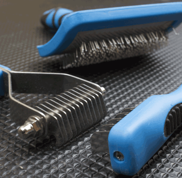 a pair of scissors and a brush brush on a table