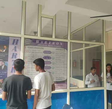 students reading Hartron poster while waiting for there next class