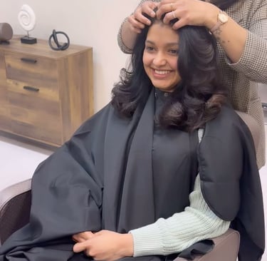 a woman getting her hair cut by a hairdresser