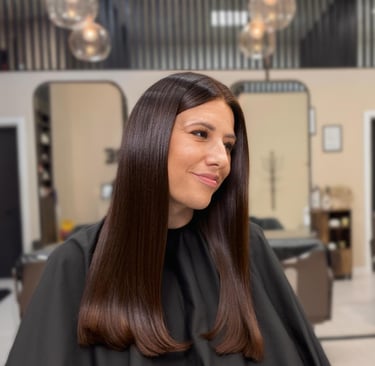 a woman in a salon with a haircut