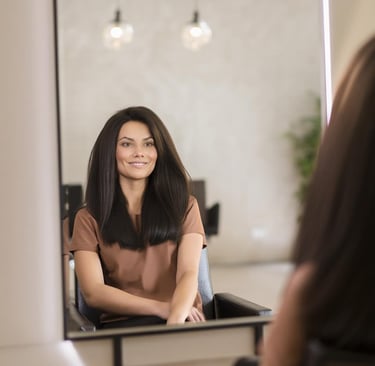 a woman in a brown dress sitting in front of a mirror