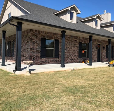 outside of new house with porch and lawn