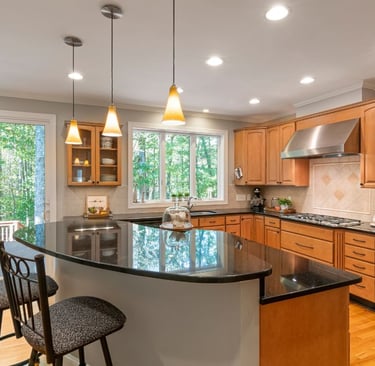 a clean kitchen with a large island and a bar stool
