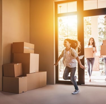 a woman is moving into a new clean home with boxes and her family