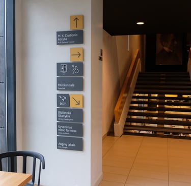 Museum signage example. Grey, mustard and light grey colours. 