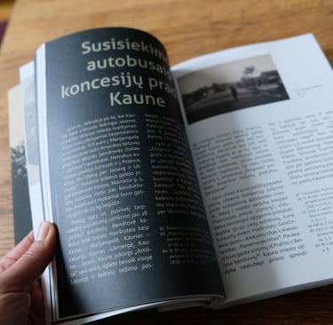 The photo shows the pages of a book being turned. The vintage photograph and the textual information are visible. 