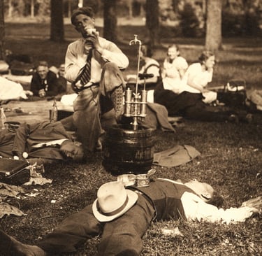 Party in the forest. People drinking and sleeping.