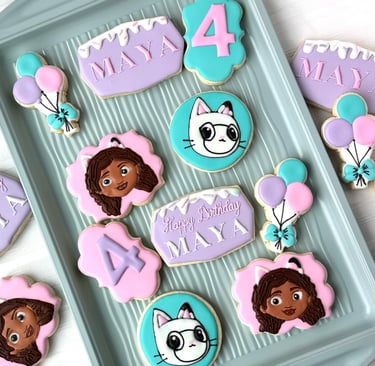 a tray of decorated birthday cookies