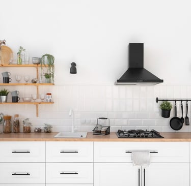 a kitchen with a stove top and shelves with pots and utensils