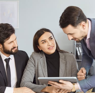 a man and woman in business attire sitting at a table