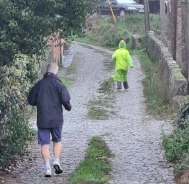 runners on a cobbled road in rain