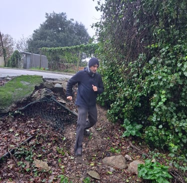 runner descending muddy bank