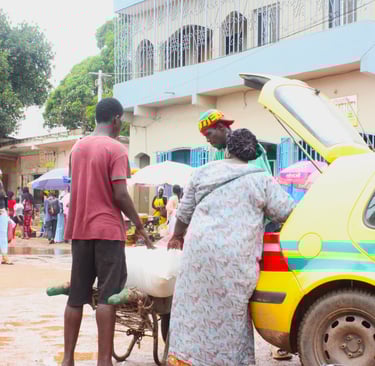 a seller negotiating price with taxi driver in The Gambia