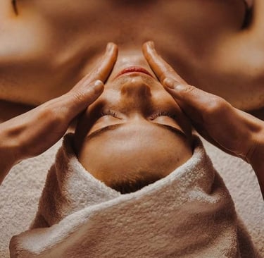 a woman getting a facial massage at a spa