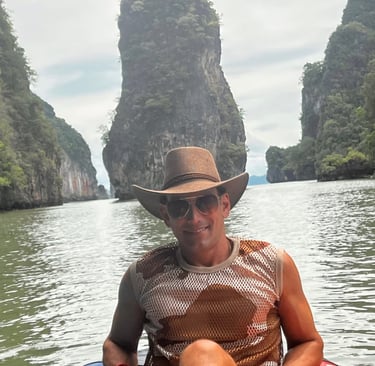 Travel writer Rick Silvia kayaks in Kong Bay with gigantic limestones in the background