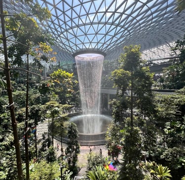a waterfall in a large indoor dome Jewel Changi Airport