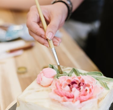 Kinntor project a person is cutting into a cake with a knife and a knife