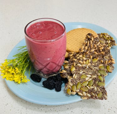 berry yoghurt drink on a plate with seed crackers