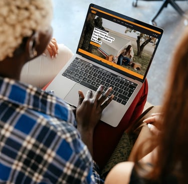 a Black woman typing on a laptop
